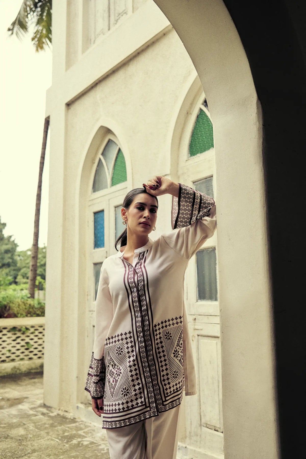 Model in a striped co-ord set under a chapel arch
